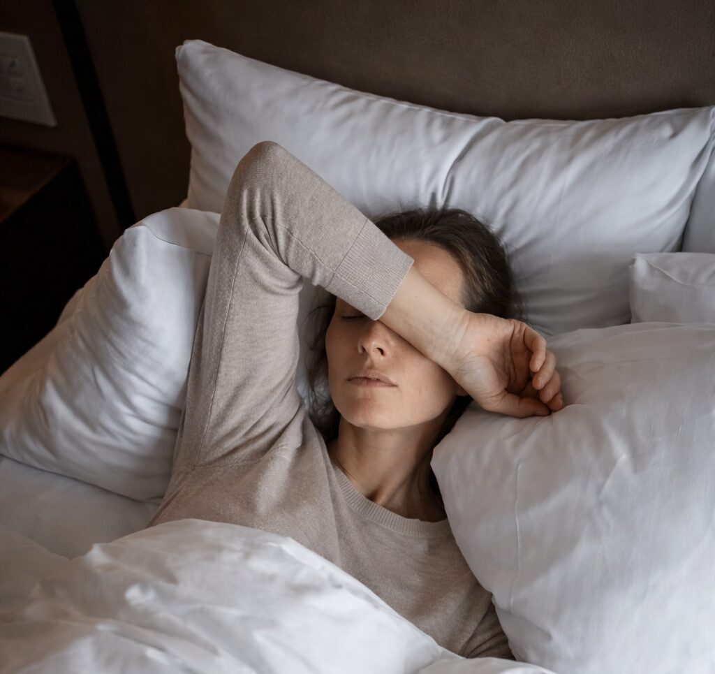person in bed looking tired
